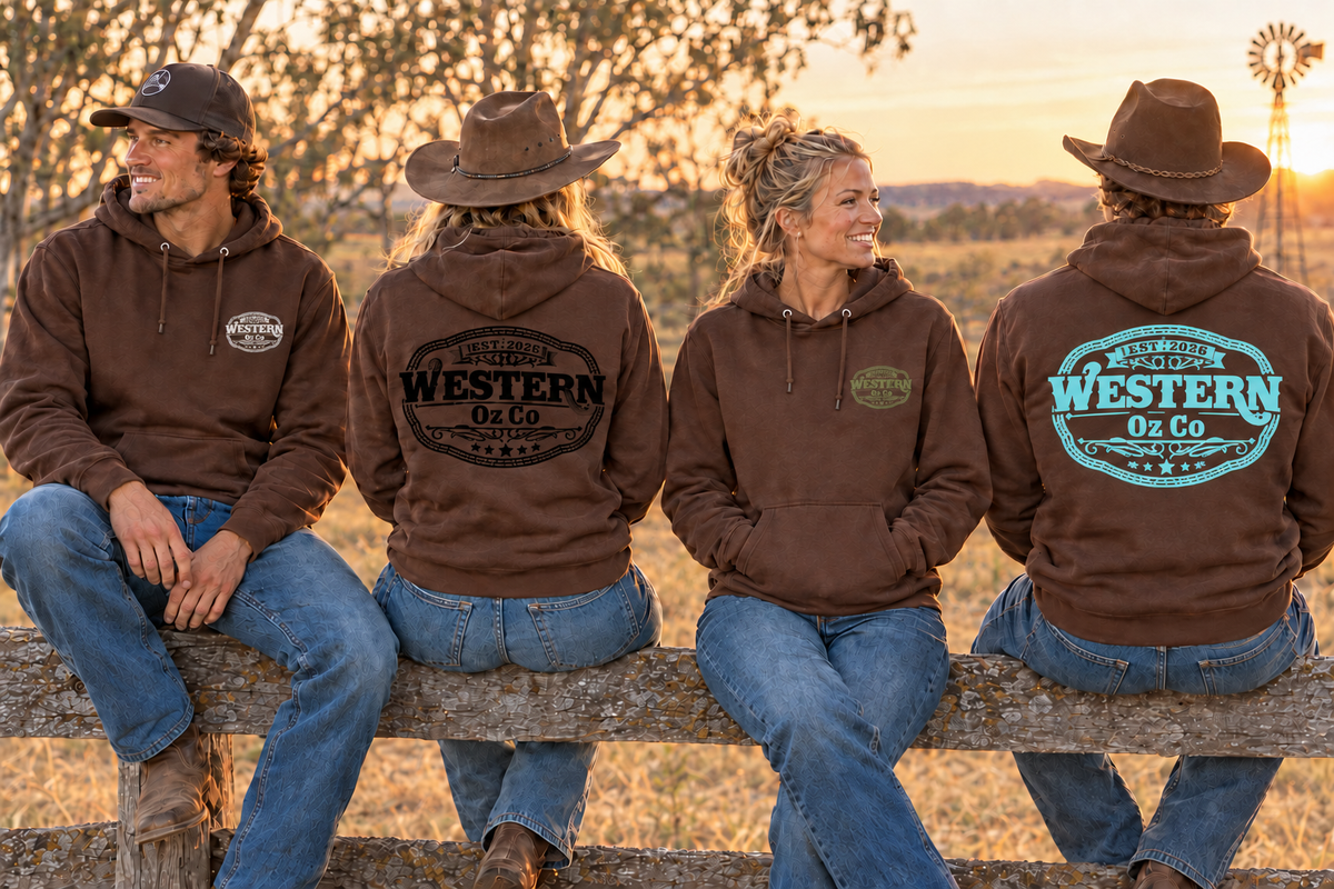 Four adults in brown Western Oz Co hoodies on a farm fence, showing white, black, army green and light turquoise logo prints