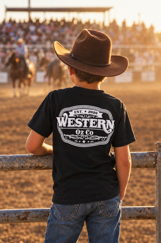 Boy at a rodeo wearing a black Western Oz Co tee with white back logo