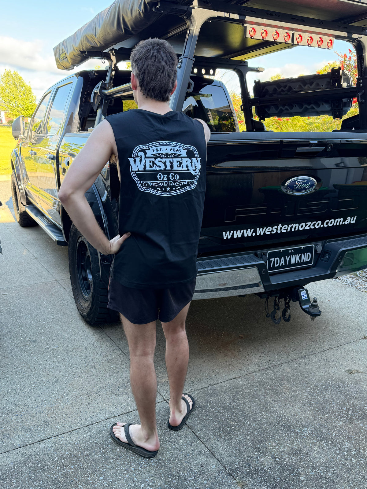 Side and rear view of black Western Oz Co muscle shirt with white logo