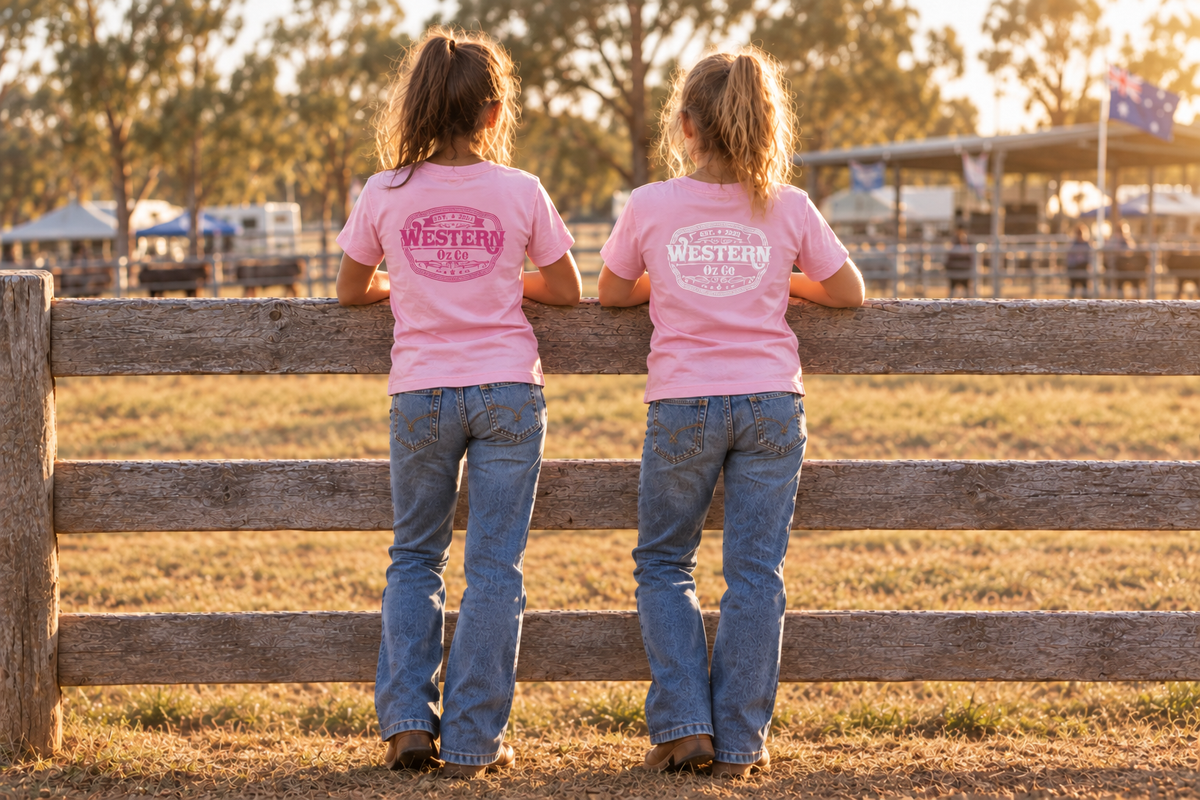 Older girls wearing pink Molly Tees with smaller darker-pink and white Western Oz Co logos