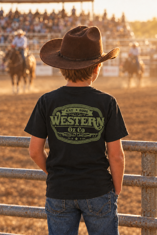 Boy at a rodeo wearing a black Western Oz Co tee with army-green back logo